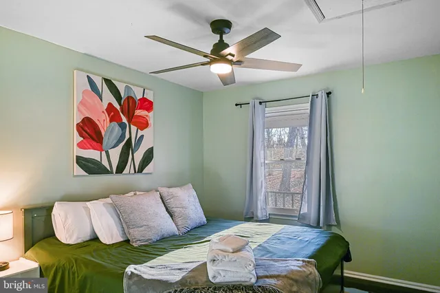 a bedroom with a bed and a painting on the wall