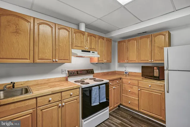 a kitchen with granite countertop cabinets stainless steel appliances and sink