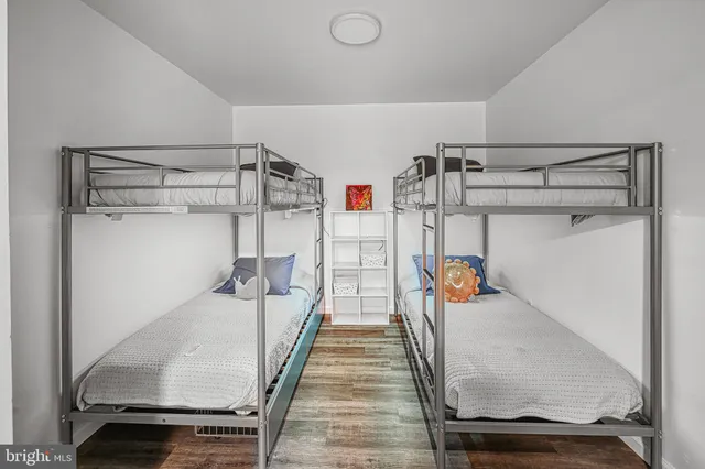 a view of a house with a large window and wooden fence