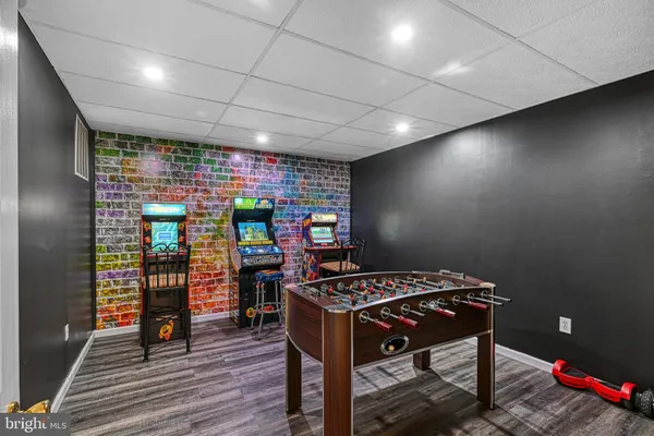a view of a room with lots of wooden furniture and windows