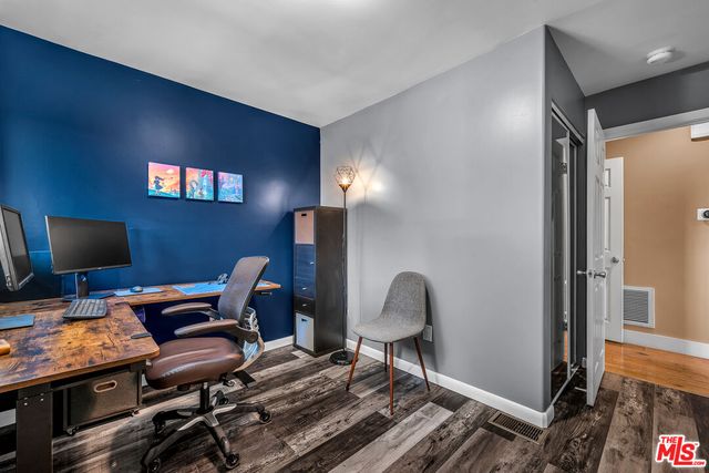 a view of a workspace with furniture and a window