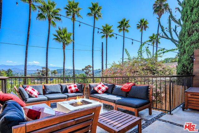 an outdoor living space with patio furniture and a potted plant