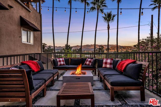 a roof deck with a couch and an ocean view