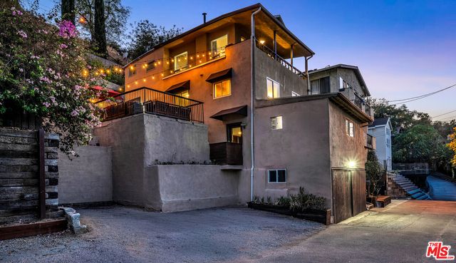 a view of a house with a yard and garden