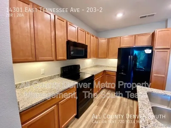 a kitchen with a stove a sink and a microwave