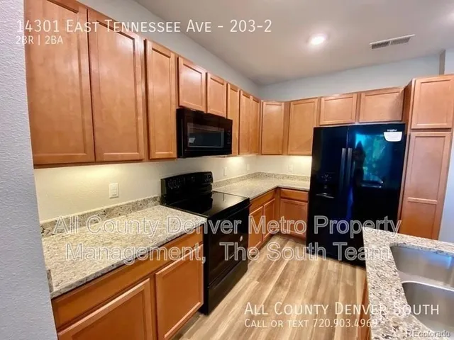 a kitchen with a stove a sink and a microwave