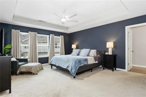 a spacious bedroom with a bed and a couch