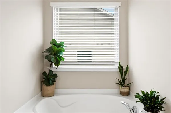 a white bath tub with a window