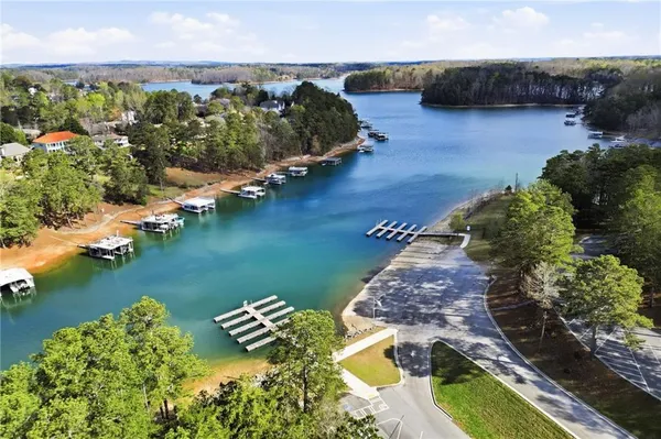 an aerial view of a house with a garden and lake view