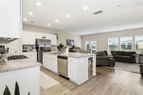 a kitchen with sink stove top oven and refrigerator