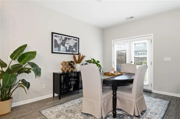 a dining room with furniture and potted plant