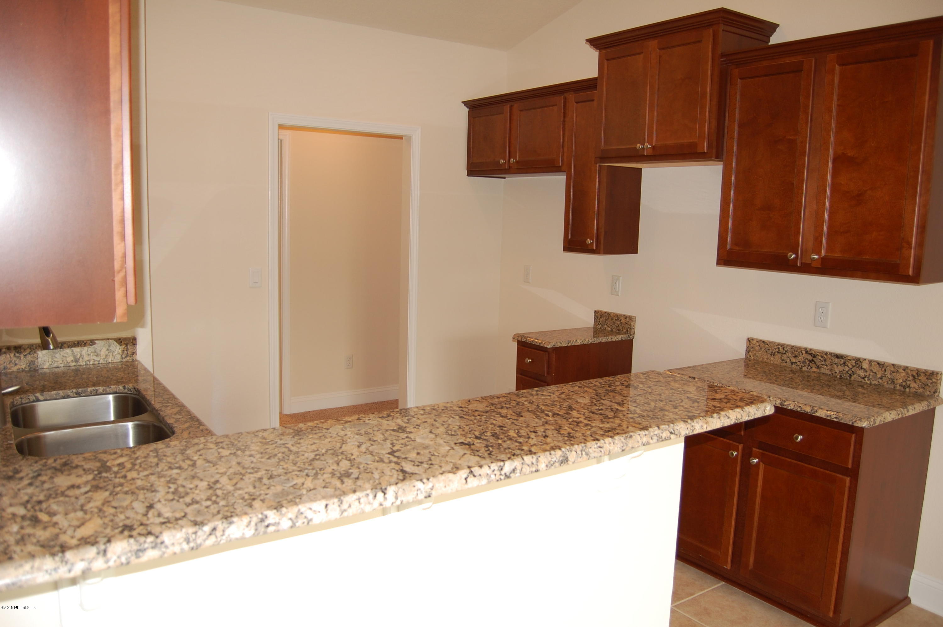 8000 Capeside Way Jacksonville, FL 32222 - Photo 13 of 32 a kitchen with granite countertop wooden cabinets and a granite counter tops