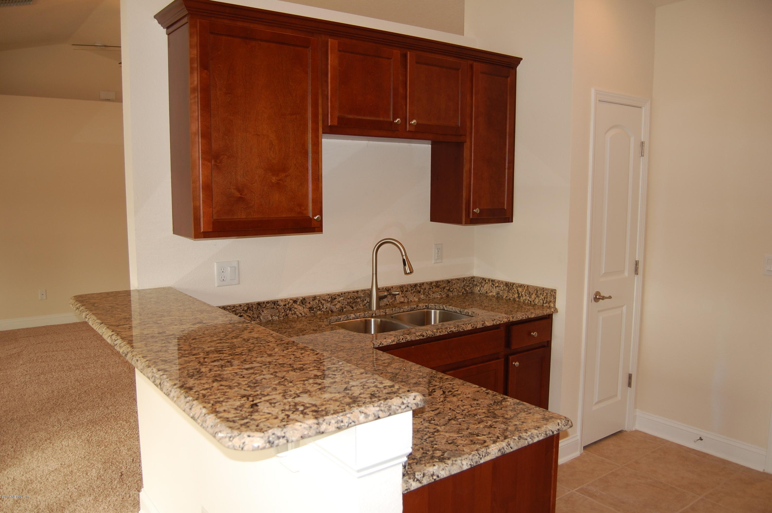 8000 Capeside Way Jacksonville, FL 32222 - Photo 15 of 32 a bathroom with a granite countertop sink and a mirror