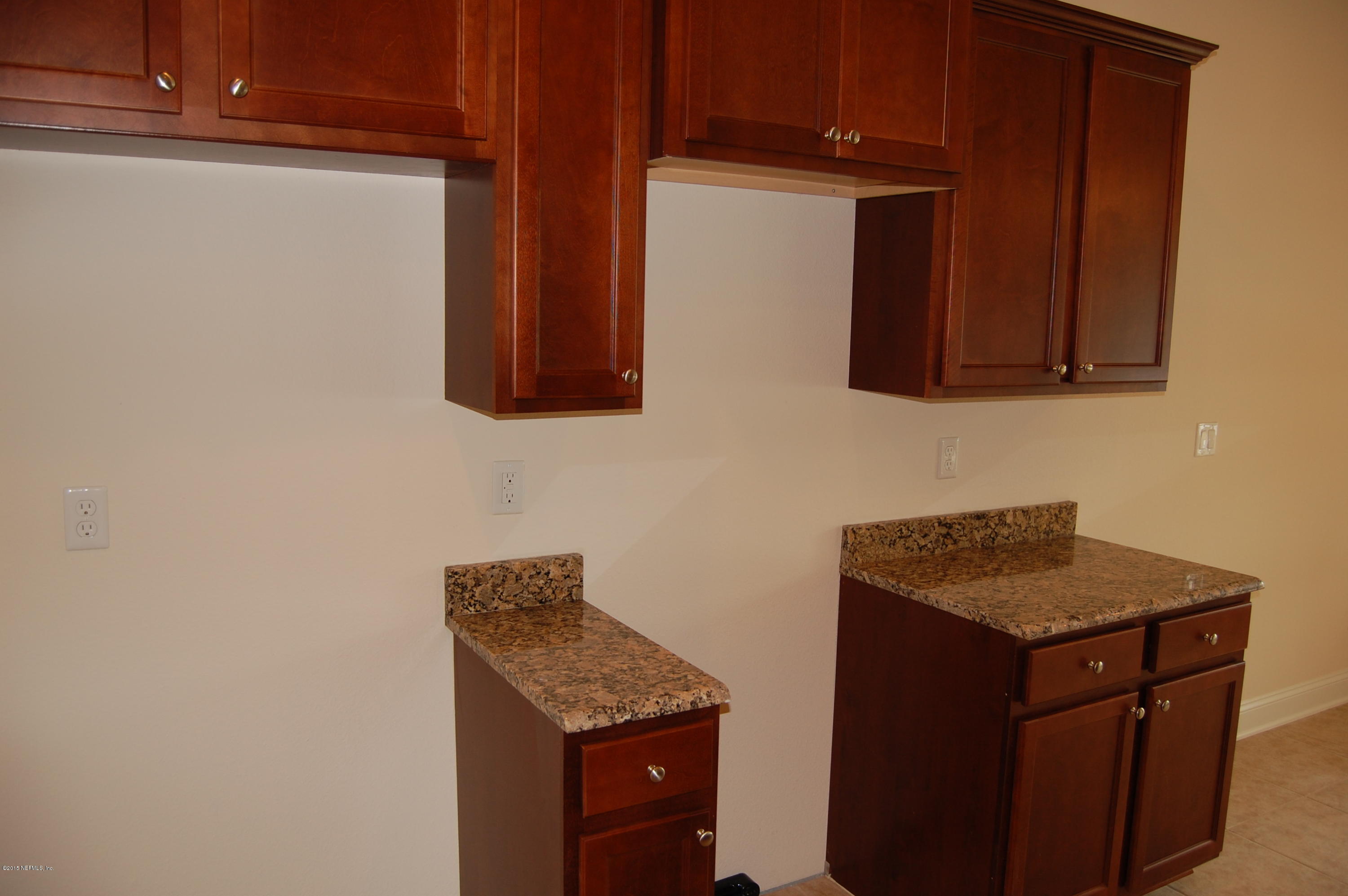 8000 Capeside Way Jacksonville, FL 32222 - Photo 16 of 32 a kitchen with granite countertop cabinets and black appliances