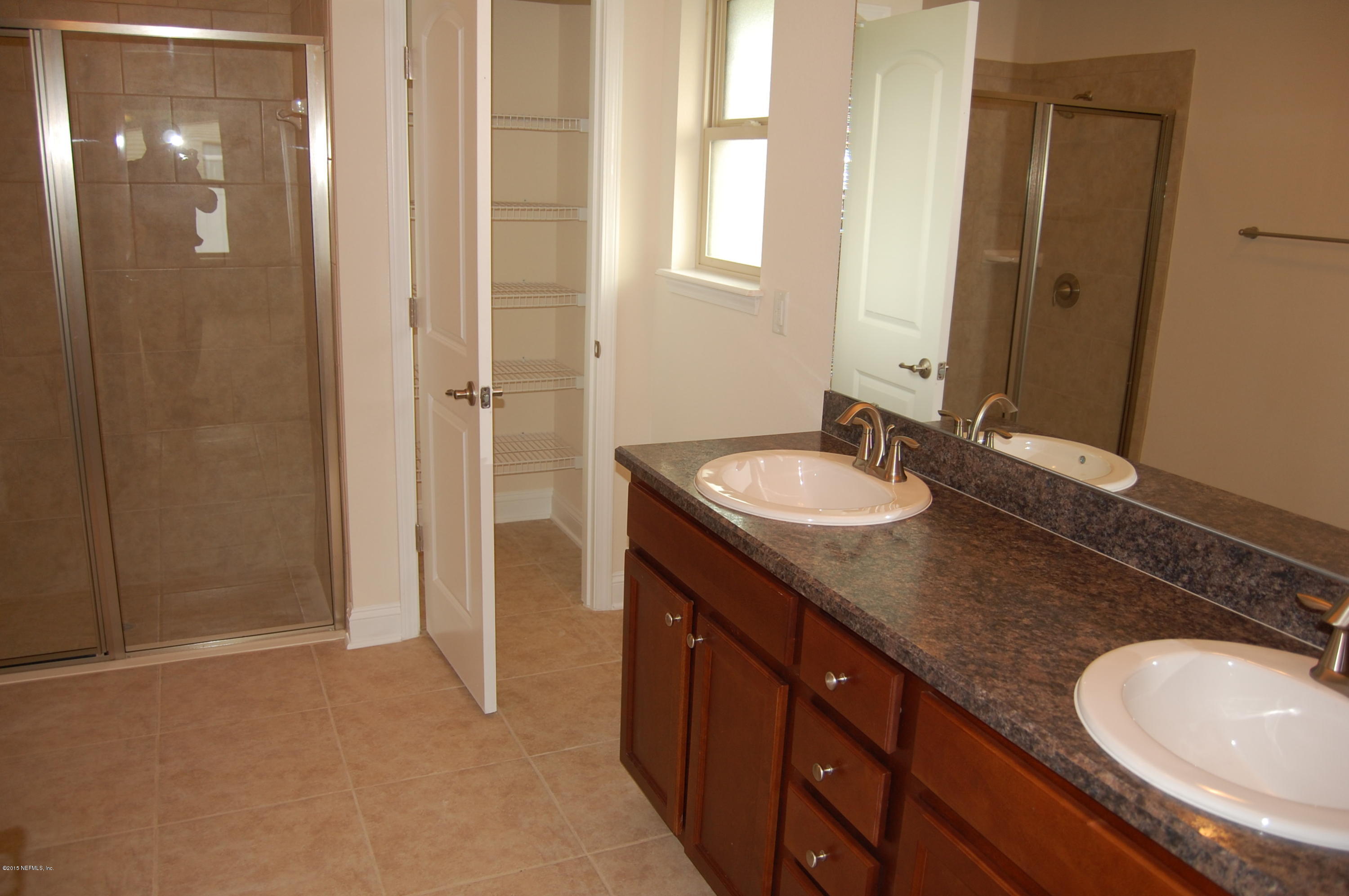 8000 Capeside Way Jacksonville, FL 32222 - Photo 20 of 32 a bathroom with a granite countertop sink and a mirror