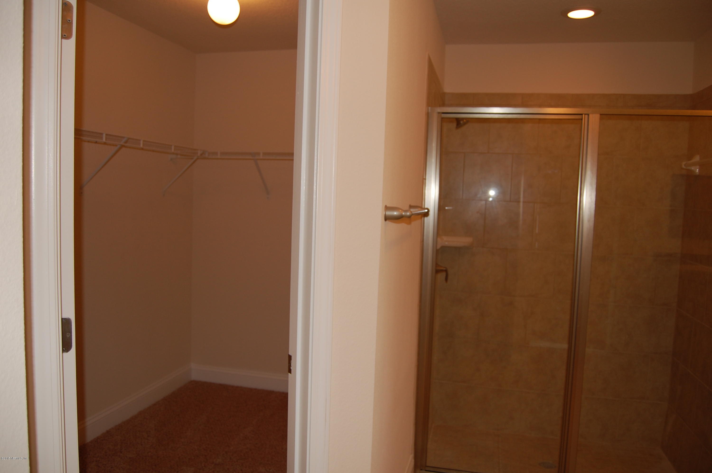 8000 Capeside Way Jacksonville, FL 32222 - Photo 22 of 32 a bathroom with a glass shower door