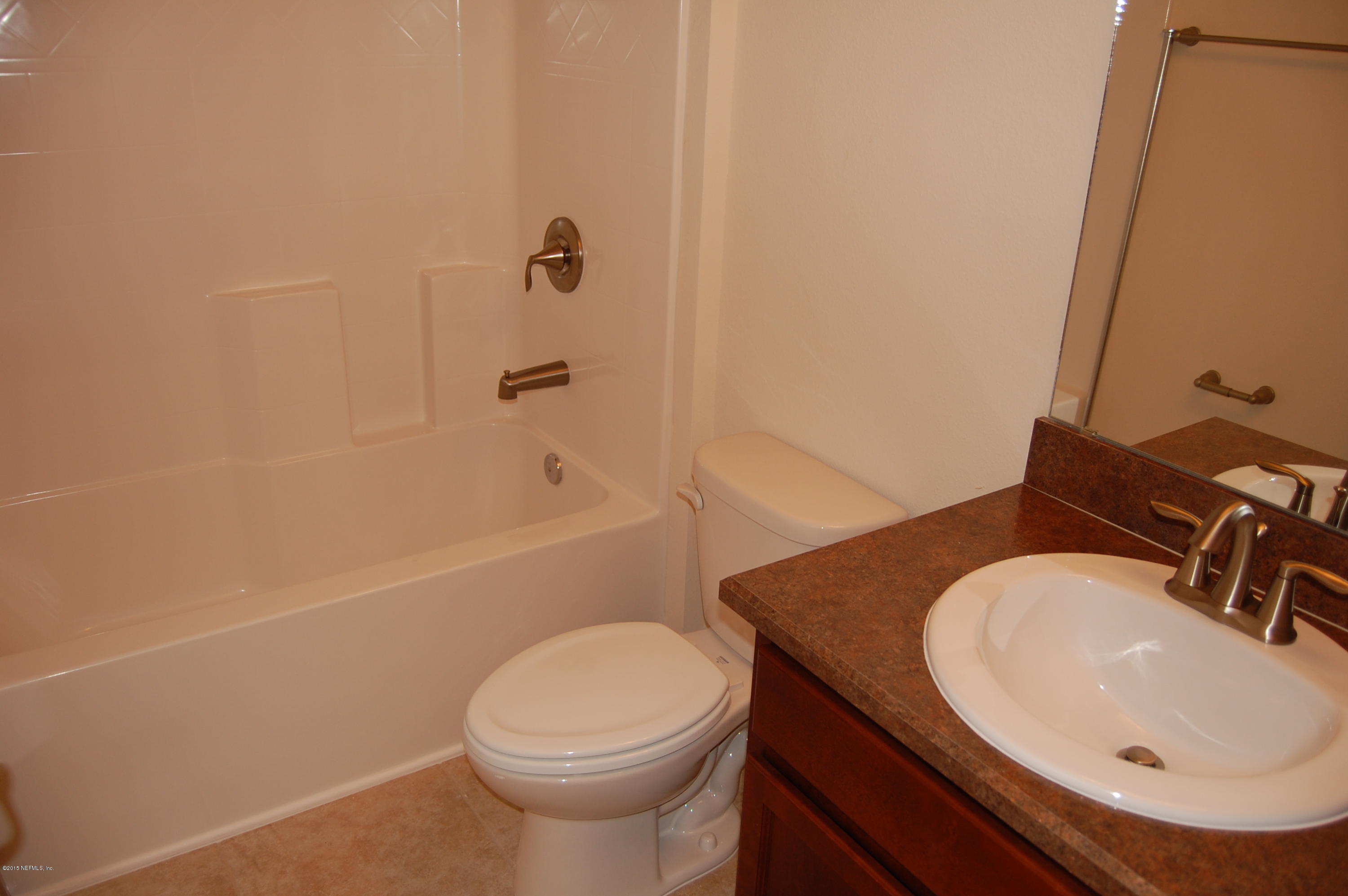 8000 Capeside Way Jacksonville, FL 32222 - Photo 27 of 32 a bathroom with a sink a toilet and shower