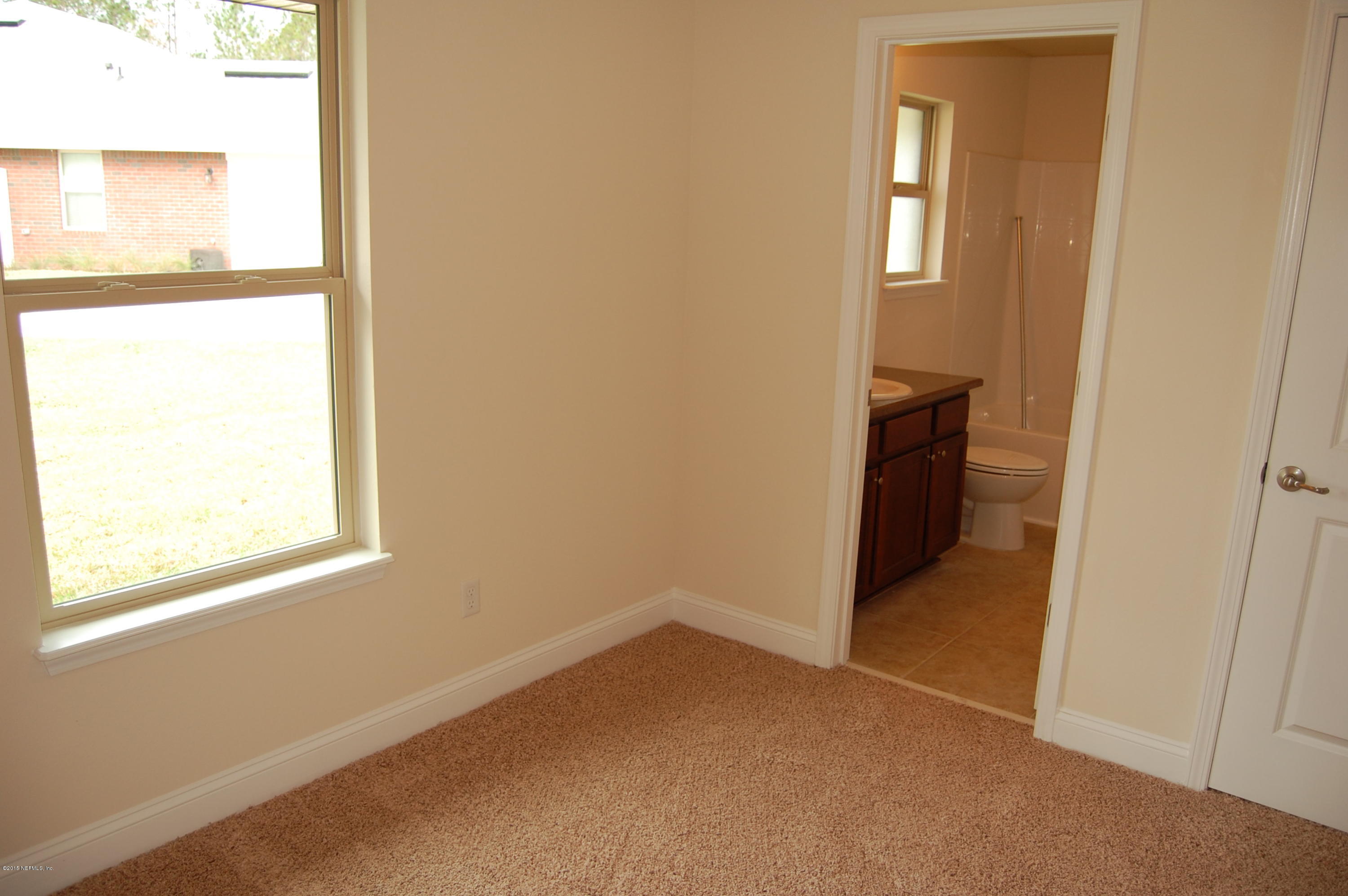 8000 Capeside Way Jacksonville, FL 32222 - Photo 29 of 32 an empty room with windows and closet