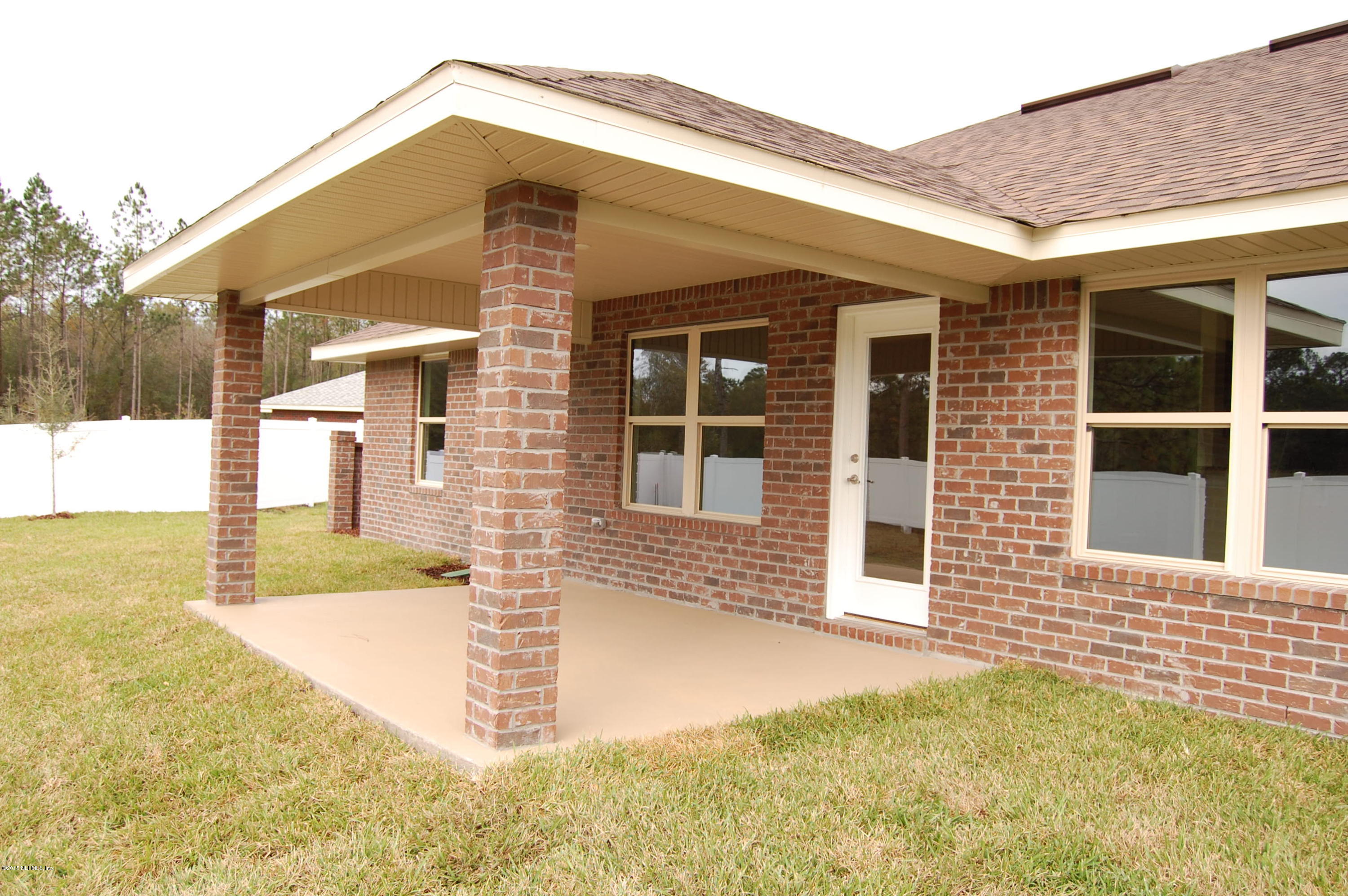 8000 Capeside Way Jacksonville, FL 32222 - Photo 5 of 32 a front view of a house with a yard