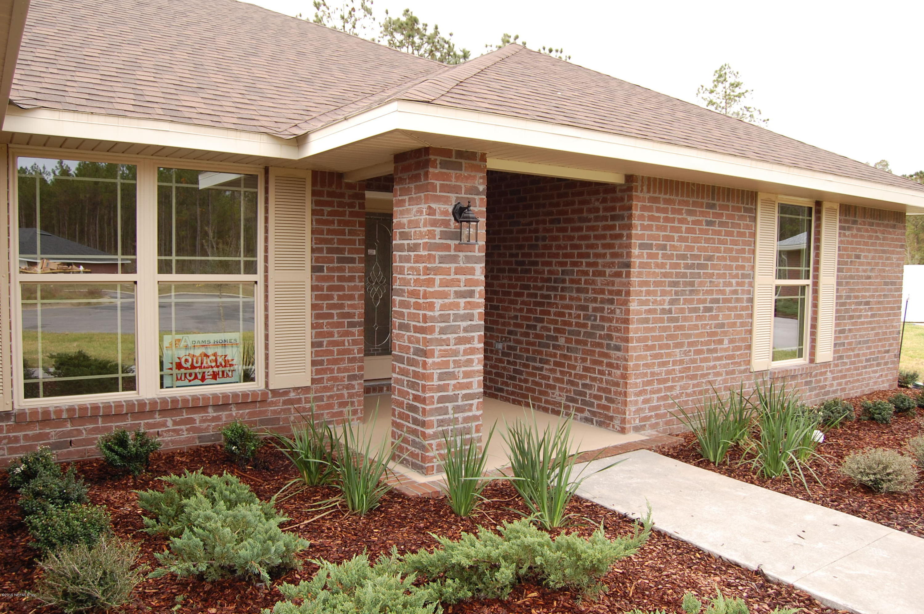 8000 Capeside Way Jacksonville, FL 32222 - Photo 6 of 32 a front view of a house with a yard