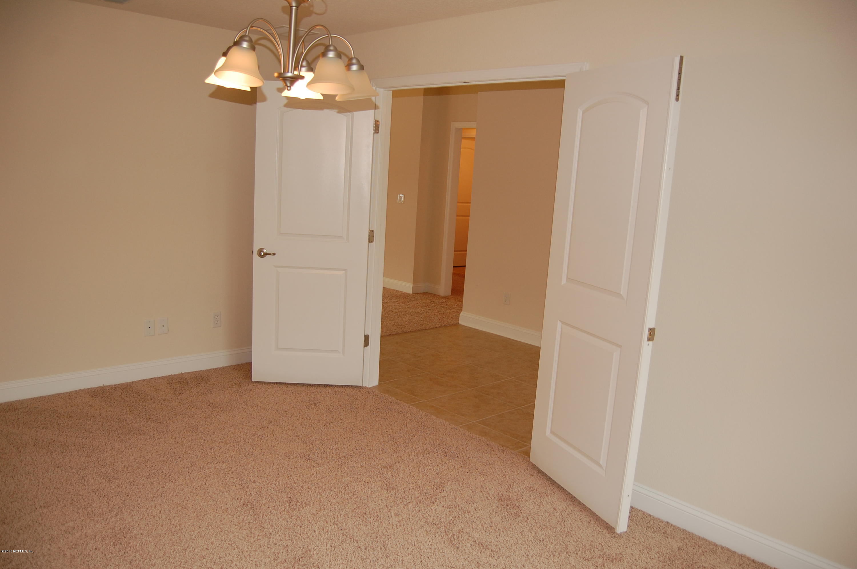 8000 Capeside Way Jacksonville, FL 32222 - Photo 10 of 32 a view of a chandelier in hallway