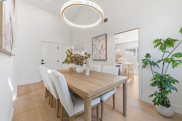 a view of a dining room with furniture and a potted plant