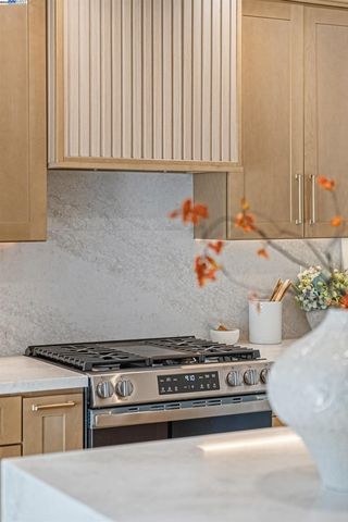 a stove top oven sitting inside of a kitchen