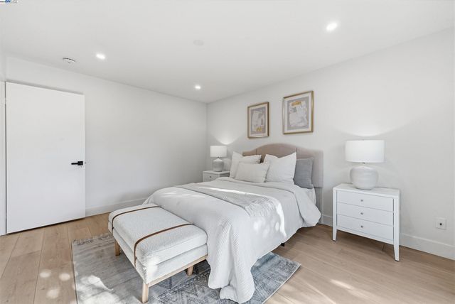 a bedroom with a bed and a night lamp