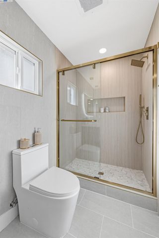 a white toilet sitting next to a bath tub shower