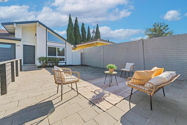 a backyard of a house with table and chairs
