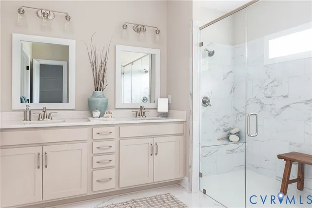 a bathroom with a shower sink and mirror
