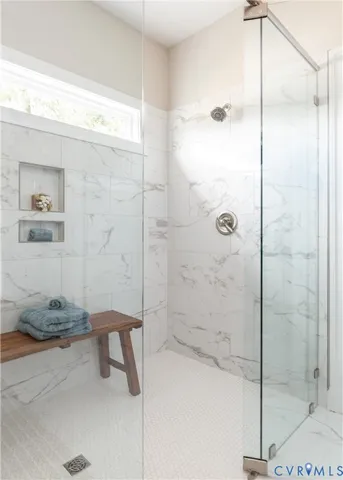 a bathroom with a granite countertop sink a shower and a mirror