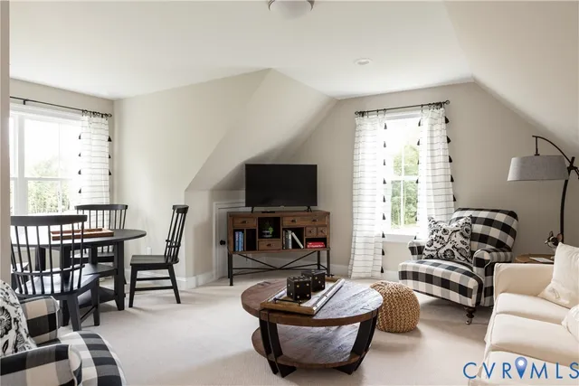 a living room with furniture a flat screen tv and a large window