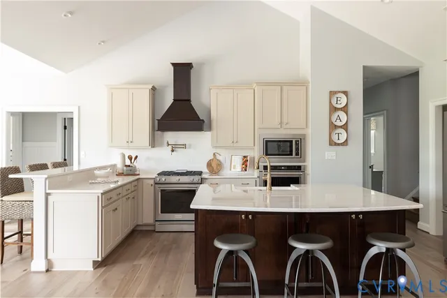 a kitchen with stainless steel appliances a sink stove and refrigerator