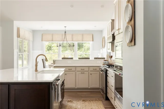 a view of a kitchen with a sink a window and stainless steel appliances