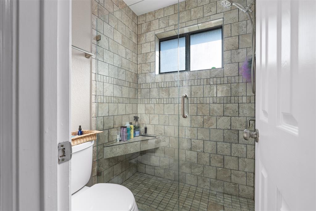 10159 Powderhorn Road Fort Worth, TX 76108 - Photo 12 of 21 a bathroom with a toilet and a shower