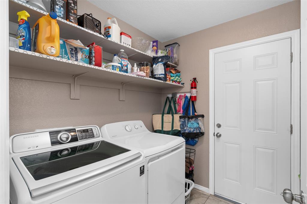 10159 Powderhorn Road Fort Worth, TX 76108 - Photo 17 of 21 a utility room with dryer and washer