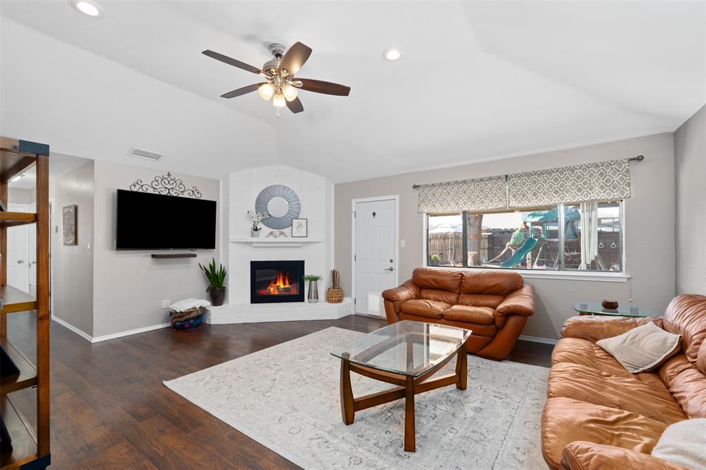 10159 Powderhorn Road Fort Worth, TX 76108 - Photo 5 of 21 a living room with furniture a fireplace and a flat screen tv