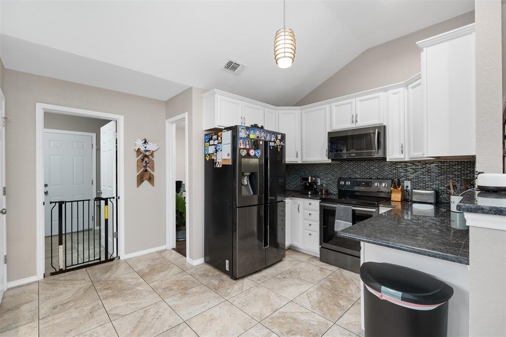 10159 Powderhorn Road Fort Worth, TX 76108 - Photo 6 of 21 a kitchen with stainless steel appliances granite countertop a refrigerator stove and microwave