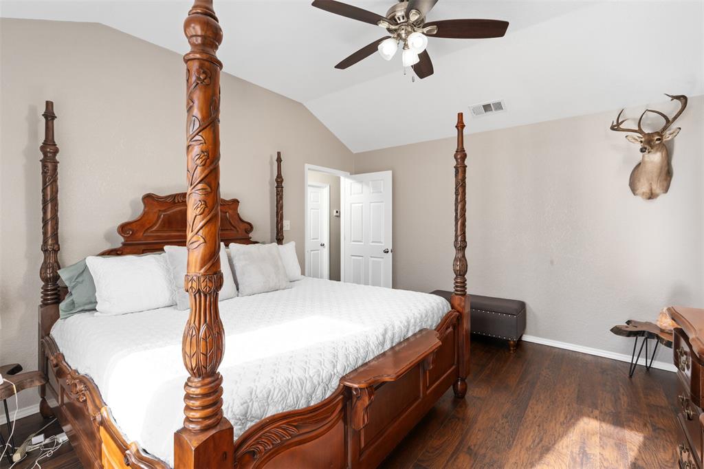 10159 Powderhorn Road Fort Worth, TX 76108 - Photo 10 of 21 a bedroom with a bed and a chandelier