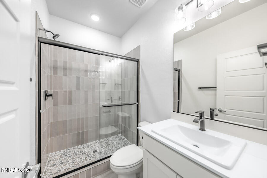 160 Rissone Lane, Unit 32 Reno, NV 89503 - Photo 5 of 5 a bathroom with a sink toilet a mirror and shower