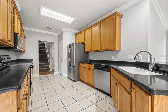 a kitchen with stainless steel appliances granite countertop a sink stove and refrigerator