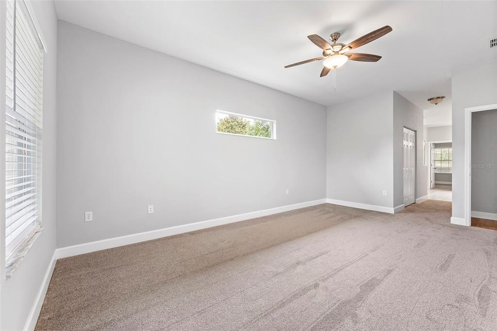 8376 Southwest 80th Place Gainesville, FL 32608 - Photo 16 of 37 an empty room with a window and a fan