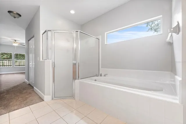 a spacious bathroom with a bathtub and a shower