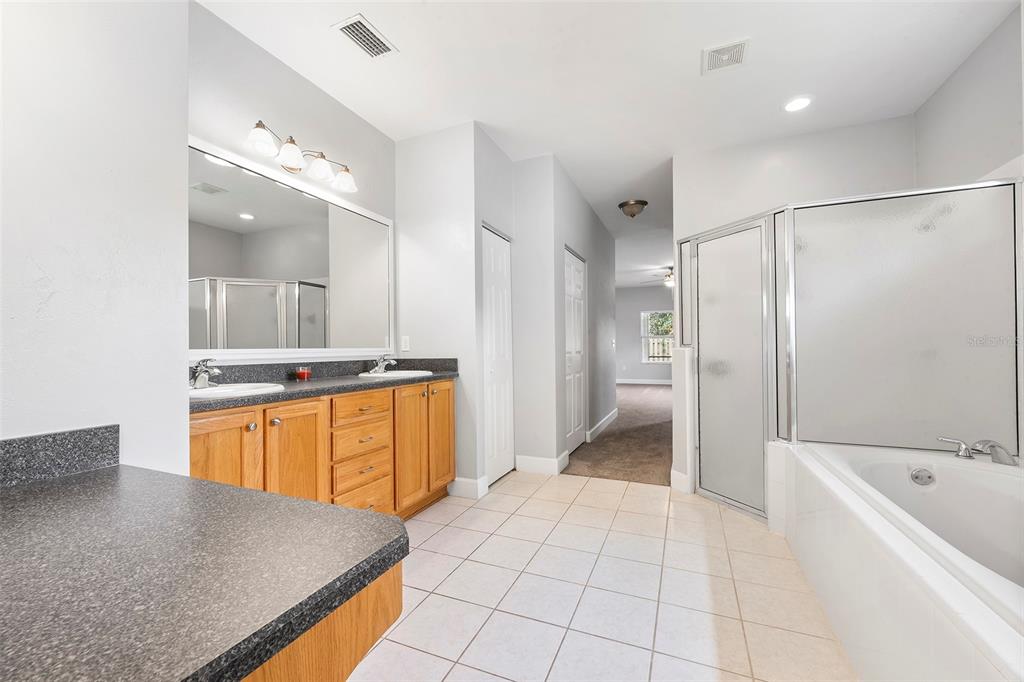 8376 Southwest 80th Place Gainesville, FL 32608 - Photo 19 of 37 a bathroom with a tub sink and mirror