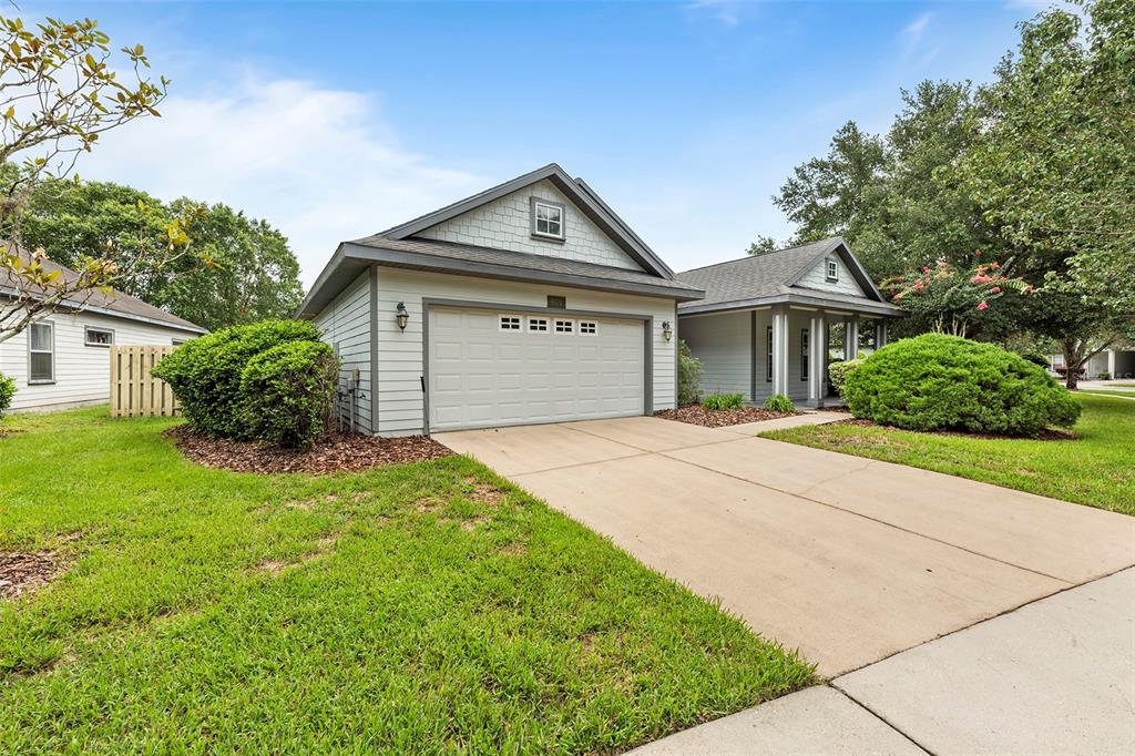 8376 Southwest 80th Place Gainesville, FL 32608 - Photo 2 of 37 a front view of a house with a yard and garage