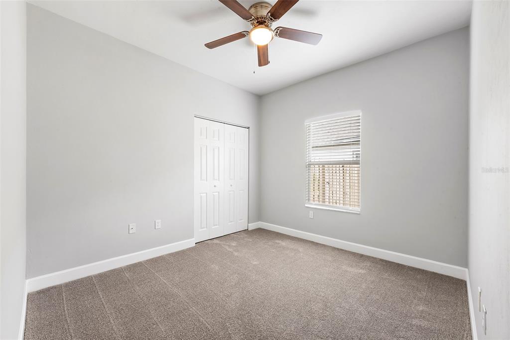 8376 Southwest 80th Place Gainesville, FL 32608 - Photo 21 of 37 an empty room with a window and a fan