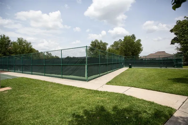 a view of a yard with a big yard and potted plants
