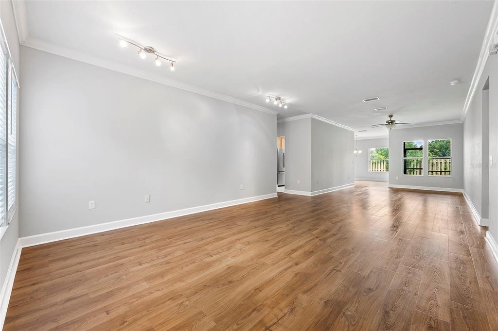 8376 Southwest 80th Place Gainesville, FL 32608 - Photo 4 of 37 a view of an empty room with wooden floor and a window