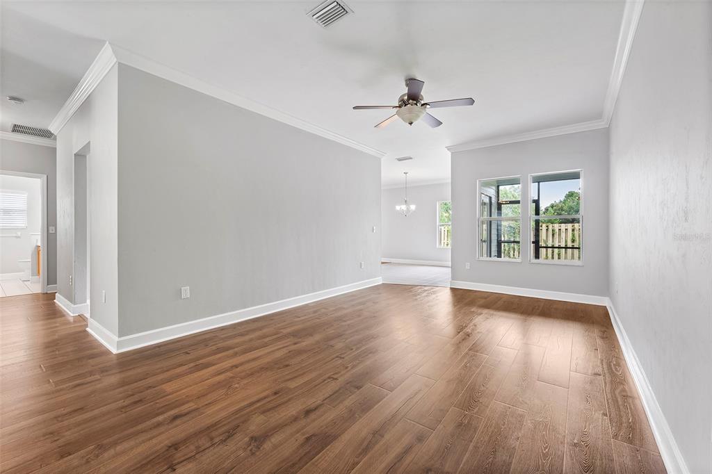 8376 Southwest 80th Place Gainesville, FL 32608 - Photo 5 of 37 a view of an empty room with wooden floor and a window